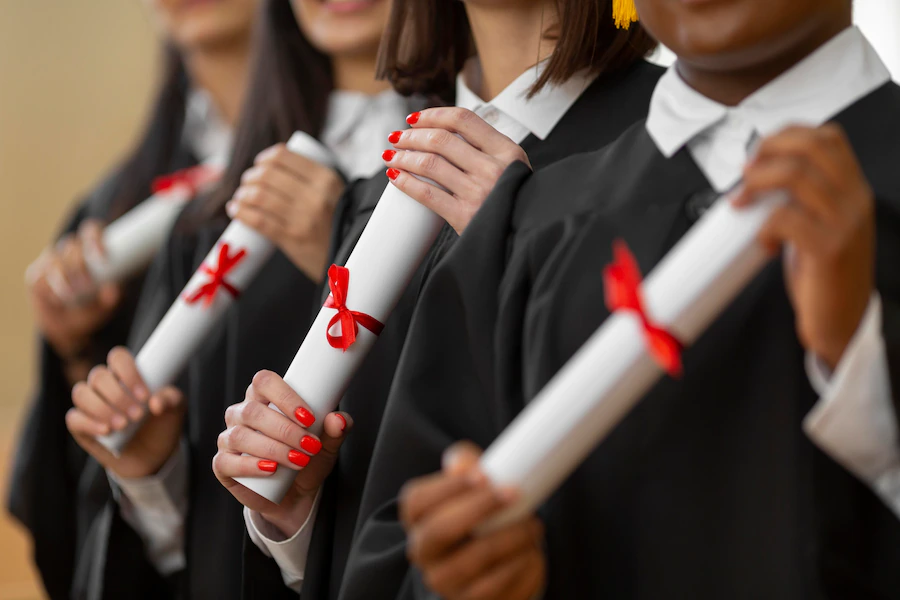 people-graduating-with-diplomas-close-up_23-2148950542